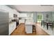 Modern kitchen with granite countertops, stainless steel appliances, and an island with a breakfast bar with view of dining area at 215 Giant Oak Ave, Statesville, NC 28677
