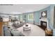 Open concept living room with a fireplace and hardwood flooring seamlessly flowing into a modern kitchen at 215 Giant Oak Ave, Statesville, NC 28677