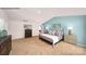 A cozy main bedroom featuring a light blue accent wall, neutral carpet, and a spacious layout at 215 Giant Oak Ave, Statesville, NC 28677