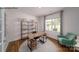 Well-lit office space with a modern desk, shelving, and a comfortable accent chair at 215 Giant Oak Ave, Statesville, NC 28677