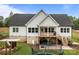 Back exterior view with a deck, patio, and a well-maintained lawn at 2336 Beth Haven Church Rd, Denver, NC 28037