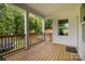 Covered deck featuring wood flooring and views of the landscaped backyard at 2336 Beth Haven Church Rd, Denver, NC 28037