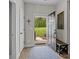 Charming entryway with a view into the backyard and a rustic bench and a 