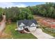 Aerial view of a modern home with a two-car garage, a driveway, and a well-manicured lawn with landscaping at 2336 Beth Haven Church Rd, Denver, NC 28037