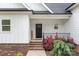 Close up of the front door with brick steps and colorful flowers that welcomes you into the home at 2336 Beth Haven Church Rd, Denver, NC 28037