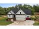Attractive home with a two-car garage, a curved walkway, a well-maintained lawn, and colorful flowers at 2336 Beth Haven Church Rd, Denver, NC 28037