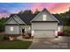 Charming two-story home with a well-manicured lawn, black roof, white siding, and a two-car garage at 2336 Beth Haven Church Rd, Denver, NC 28037