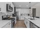 Kitchen features stainless steel appliances, white cabinets, marble backsplash and quartz countertops at 2336 Beth Haven Church Rd, Denver, NC 28037