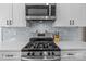 Kitchen features a stainless steel stove, range hood, microwave, and marble backsplash at 2336 Beth Haven Church Rd, Denver, NC 28037