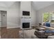 Cozy living room with a fireplace, a mounted TV, and comfortable seating with lots of natural light at 2336 Beth Haven Church Rd, Denver, NC 28037