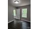 Bedroom with dark wood floors, gray walls, white trim, natural light from window overlooking trees at 2514 Oak Valley Ln # 4 & 5, Maiden, NC 28650