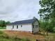 Rear exterior view of a new construction home featuring vinyl siding and a wooded backyard at 2514 Oak Valley Ln # 4 & 5, Maiden, NC 28650