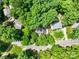 An aerial view showcasing a beautiful home nestled in a lush green neighborhood with mature trees and landscaping at 2731 Creekbed Ln, Charlotte, NC 28210