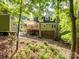 Expansive backyard view showcasing the shed and wooden deck, offering a private outdoor space at 2731 Creekbed Ln, Charlotte, NC 28210