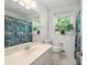 Bright bathroom with a large mirror, window, and a fish-themed shower curtain bringing color and cheerfulness at 2731 Creekbed Ln, Charlotte, NC 28210