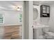 Partial view of a charming bathroom adjacent to a bedroom with wood flooring and natural light at 2731 Creekbed Ln, Charlotte, NC 28210