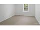 Neutral carpeted bedroom with a large window bringing in plenty of sunlight at 2731 Creekbed Ln, Charlotte, NC 28210