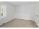 Cozy bedroom featuring carpet floor, window with natural light, and white trim at 2731 Creekbed Ln, Charlotte, NC 28210