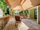 Spacious deck with canopy is perfect for relaxation, featuring sturdy railings and providing views of the backyard at 2731 Creekbed Ln, Charlotte, NC 28210