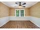 Formal dining room featuring chair rail, hardwood floors, and a ceiling fan at 2731 Creekbed Ln, Charlotte, NC 28210