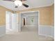View of the dining room and adjacent hall with ceiling fan and trim at 2731 Creekbed Ln, Charlotte, NC 28210