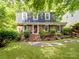 Charming brick home with manicured lawn, mature trees, and a welcoming front entrance at 2731 Creekbed Ln, Charlotte, NC 28210