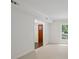 Bright hallway with neutral carpet leading to colorful front door at 2731 Creekbed Ln, Charlotte, NC 28210