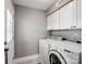 Convenient laundry room with washer, dryer, and overhead cabinets at 2731 Creekbed Ln, Charlotte, NC 28210