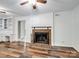 Inviting living room featuring hardwood floors, a brick fireplace, built-in shelving, and neutral paint at 2731 Creekbed Ln, Charlotte, NC 28210