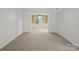 Bright living room with neutral carpet and window views to adjacent space at 2731 Creekbed Ln, Charlotte, NC 28210