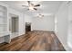 Sunlit living room featuring hardwood floors, a brick fireplace, built-in shelving, and neutral paint at 2731 Creekbed Ln, Charlotte, NC 28210