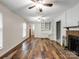 Open-concept living room with a cozy fireplace, hardwood floors, and built-in shelves at 2731 Creekbed Ln, Charlotte, NC 28210