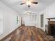 Bright living room featuring hardwood floors, a brick fireplace, built-in shelving, and neutral paint at 2731 Creekbed Ln, Charlotte, NC 28210