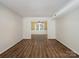 Bright living room featuring hardwood flooring, a large opening, and crown molding at 2731 Creekbed Ln, Charlotte, NC 28210