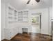 Cozy office space with custom built-ins, desk, and wood flooring at 2731 Creekbed Ln, Charlotte, NC 28210