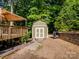 This backyard features a charming shed and wooden deck, perfect for outdoor projects and relaxation at 2731 Creekbed Ln, Charlotte, NC 28210
