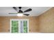 A window with white panes and brown walls with a ceiling fan at 2731 Creekbed Ln, Charlotte, NC 28210