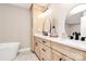 Bathroom featuring double sinks, wood cabinets, and modern fixtures at 2780 China Grove Rd, Kannapolis, NC 28083