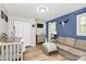 Cozy bedroom with a blue accent wall, crib, and neutral-toned furniture at 2780 China Grove Rd, Kannapolis, NC 28083