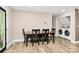 Dining area features a wooden table and access to laundry room with modern washer and dryer at 2780 China Grove Rd, Kannapolis, NC 28083