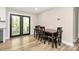 Cozy dining area with a wooden table, black chairs, and a view through glass doors at 2780 China Grove Rd, Kannapolis, NC 28083