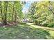 Charming home with a long porch situated among trees in a scenic, natural setting, providing privacy at 2780 China Grove Rd, Kannapolis, NC 28083