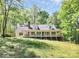 Charming home with a large covered front porch, nestled among mature trees, exudes southern comfort at 2780 China Grove Rd, Kannapolis, NC 28083