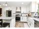 Modern kitchen with stainless steel appliances, white cabinets, and granite countertops at 2780 China Grove Rd, Kannapolis, NC 28083