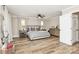 Spacious main bedroom with wood floors, neutral paint, a ceiling fan, and lots of natural light at 2780 China Grove Rd, Kannapolis, NC 28083