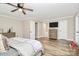 Comfortable main bedroom featuring wood floors, neutral walls, a ceiling fan, and access to an ensuite bathroom at 2780 China Grove Rd, Kannapolis, NC 28083