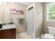 Bathroom showcasing a single sink vanity with granite countertops and a shower with modern fixtures at 3022 8Th Street Ne Ct, Hickory, NC 28601