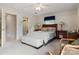 Well-lit bedroom featuring a ceiling fan, two bedside tables with lamps, and a cozy seating area at 3022 8Th Street Ne Ct, Hickory, NC 28601