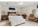 Bright bedroom with a ceiling fan, decorative lamps, stylish decor, and a comfortable seating area at 3022 8Th Street Ne Ct, Hickory, NC 28601