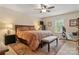 Comfortable bedroom featuring a ceiling fan, bedside tables, and a window providing natural light at 3022 8Th Street Ne Ct, Hickory, NC 28601